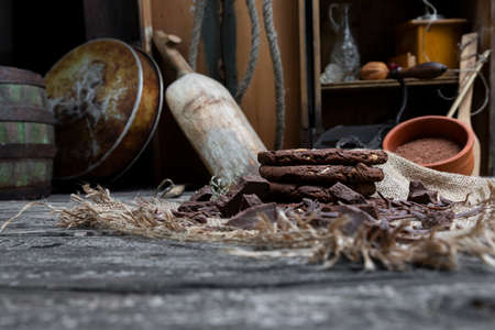 Chocolate cookies with hazelnuts , cocoa and pieces of dark chocolate on the rustic kitchen tableの写真素材