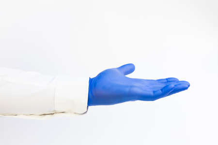 Doctor wearing blue latex Glove. Opened hand. White background. Copy spaceの写真素材