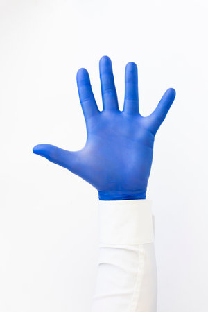 Opened palm, hand in blue latex Glove .Copy space, white backgroundの写真素材