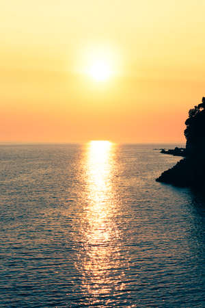 Sunset at sea. Sun reflecting out of the water surface. Beautiful golden hourの写真素材