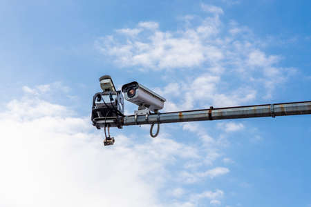 Traffic cctv camera against blue sky. Artificial intelligence and secutity conceptの写真素材