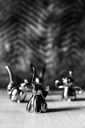 Elephant metal figurine, statue with other animals in backgroundの写真素材