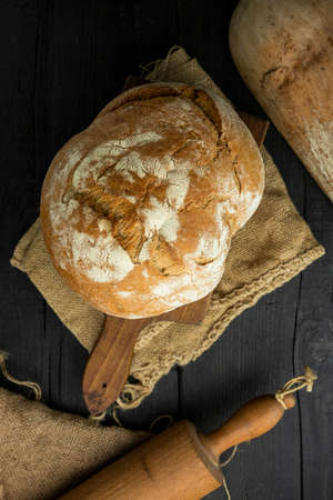 Loaf of bread in the rustic kitchen. Organic and domestic products