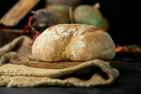 Loaf of bread in the rustic kitchen. Organic and domestic productsの写真素材