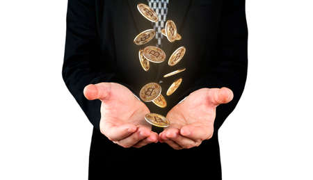 Bitcoins falling in to Businessmans hands. Cryptocurrency and banking conceptの写真素材