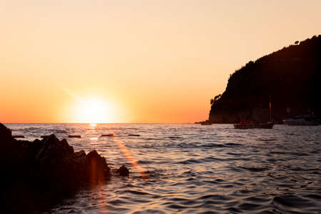 Sunset with yellow sun at the horizon at seaの写真素材