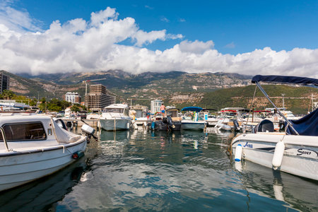 Budva, Montenegro - August 26, 2021: Boats and yachts anchored at harbour in the town of Budva, Montenegro. Luxury travel destination with beatuiful beaches at Adriatic seaのeditorial素材