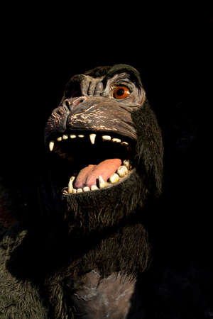 Gorilla monster. Scary and angry gorilla with big jaws and evil eyes. Puppets, toys and statues
