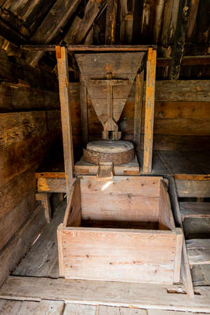Ancient mill made of stones and wood. Weet grinding machine used in making Flourの写真素材