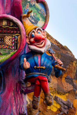 VIENNA, AUSTRIA - October 11, 2018: Dwarf with spade statue (Snow White and the seven dwarfs) in front of a fun house at amusement park Prater in Vienna, Austria.のeditorial素材