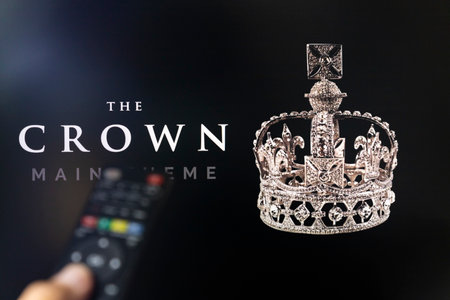 Belgrade, Serbia - September 12, 2022: Watching TV Show The Crown on Netflix with remote control in hand.  TV series is about British Royal family and Queen Elizabeth IIのeditorial素材