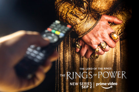 Belgrade, Serbia - September 12, 2022: The Lord of the Rings: The Rings of Power TV series on TV with remote control in hand. Story takes place thousands of years before the events of J.R.R. Tolkien's 'The Hobbit' and 'The Lord of the Rings'.のeditorial素材