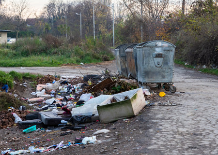 Belgrade, Serbia - November 17, 2022: Garbage pile beside dumpster scattered all over the street in...