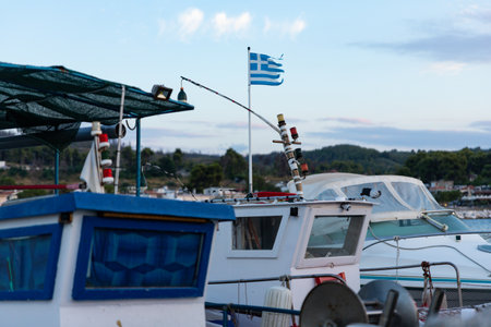Fishing boat with flag of Greece in harbour at Evia island
