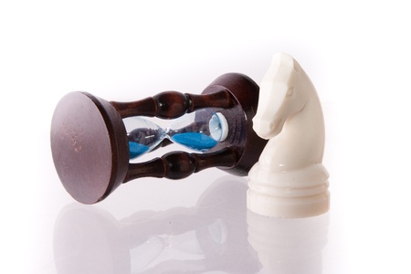 White chess horse with sand-clock isolated on whiteの写真素材