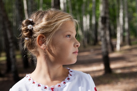 Pre-teenage girl  posing in a birch forestの写真素材