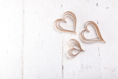 Vintage book heart shaped cutout on bleached board texture background