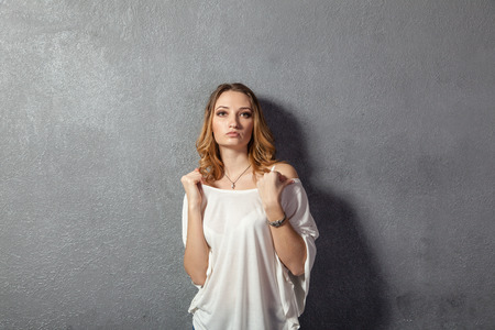 casual young woman making faces in studio