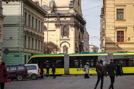 LVIV, UKRAINE - February 22, 2015: Lviv unique architecture with modern tramのeditorial素材