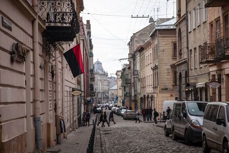 LVIV, UKRAINE - February 23, 2015: Narrow Lviv street with combat Ukrainian flagのeditorial素材