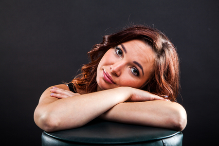 Portrait of attractive young woman on black background in studioの写真素材