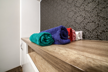 Stack of clean fresh towels on wardrobeの写真素材