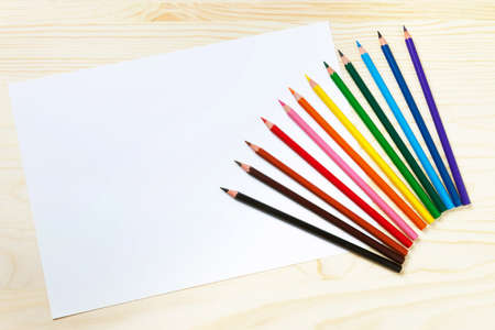 Color pencils and a sheet of paperの写真素材