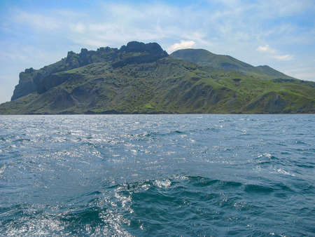 Crimea. View From The Sea To The Tele-Oba Ridge And Mount Lysuy, Kara-Dag Massif, Shrouded In A Light Haze, Near The City Of Feodossia の写真素材