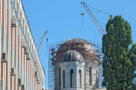 The Building Under Construction and The Dome of the Russian Orthodox Church Are Surrounded by...