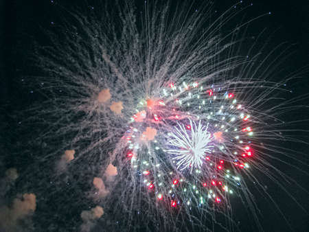 A Bright, Festive, Multi-Colored Fireball Decorated the Dark Night Sky with Flashesの写真素材