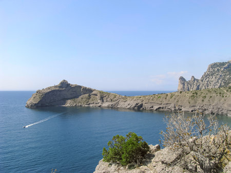 The Kara Dag Mountain Range in Crimea Is Illuminated by The Bright Rays of the Spring Sun and Stands Out Against the Background of the Blue Sky and The Seaの写真素材