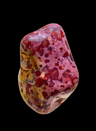 Photograph of a Polished Natural Jasper Stone in A Variegated Violet-Green Hue. Isolated On Black Backgroundの写真素材