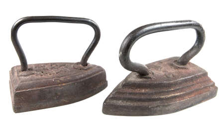 Two antique smoothing irons isolated over white backgroundの写真素材