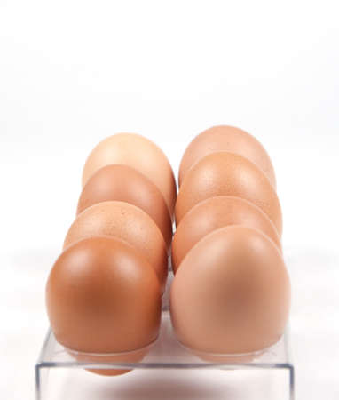 Eight brown eggs in a supportの写真素材