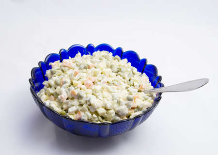"Olivier" salad in a blue glass bowlの写真素材