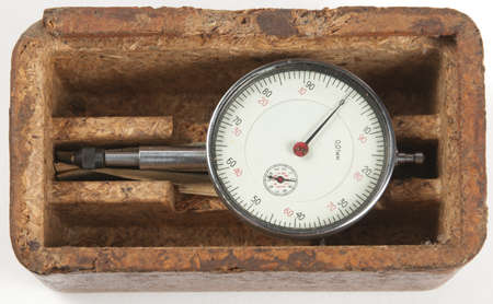 Small old mechanical curvimeter in a wooden box over a white background