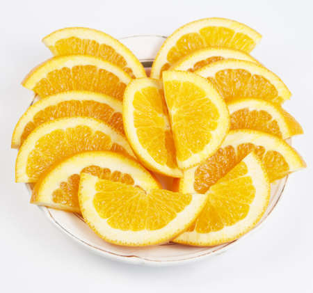 Juicy Orange cuts on a white plate, top viewの写真素材