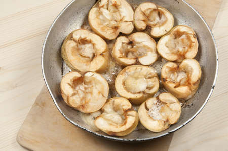 Baked apples in a frying pan on the tableの写真素材