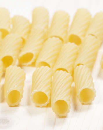 Penne pasta on a wooden table, close-upの写真素材