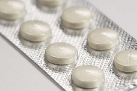 Tablets in blister over light background, macro shotの写真素材