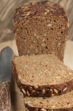 Rye and wheat bread with sunflower seeds on a wooden table