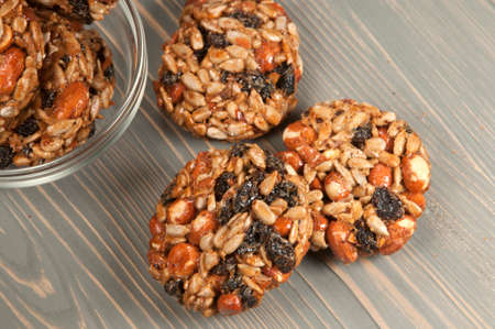 Brittle from assorted ingredients - peanut, raisins and sunflower seeds