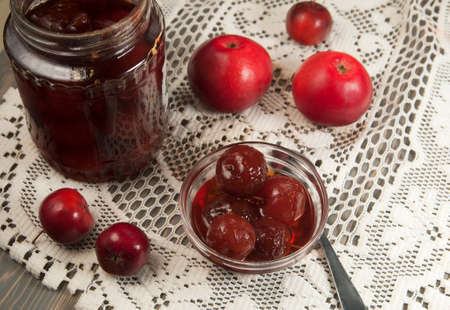 Apple jam in a bowl on a wooden table