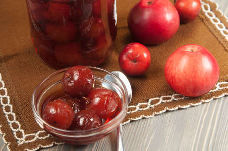 Apple jam in a bowl on a wooden table