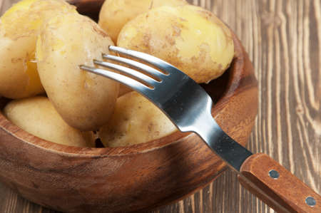 Boiled Young potatoes in a wooden bowlの写真素材