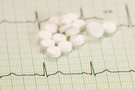 Tablets on electrocardiogram paper, closeup shot, local focusの写真素材