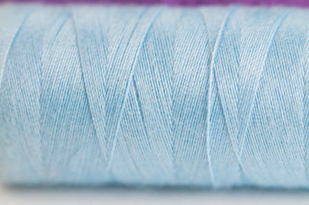 Sewing strings on a light background, macro shot, local focus