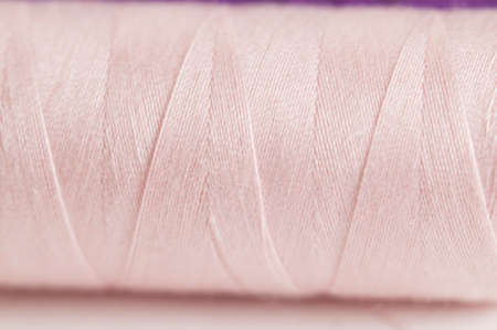 Sewing strings on a light background, macro shot, local focus