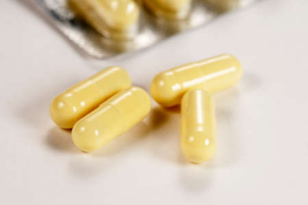 Capsulas of antibiotic over light background, macro shot