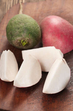Radish cuts on a timber board, close upの写真素材